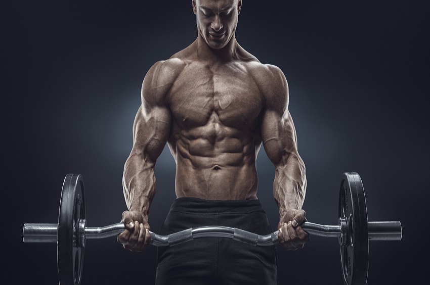 Closeup portrait of a muscular man workout with barbell at gym